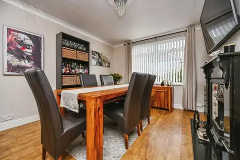 Separate dining room with feature fireplace and large front window