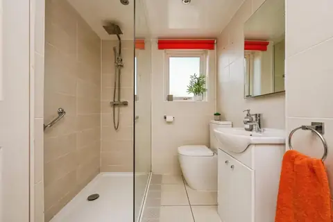 Ground-floor shower room with walk-in shower, basin and WC